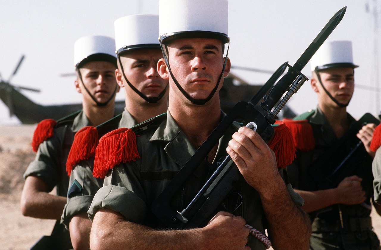 Un groupe de soldats de la Légion Étrangère en uniforme avec képis blancs et épaulettes rouges
